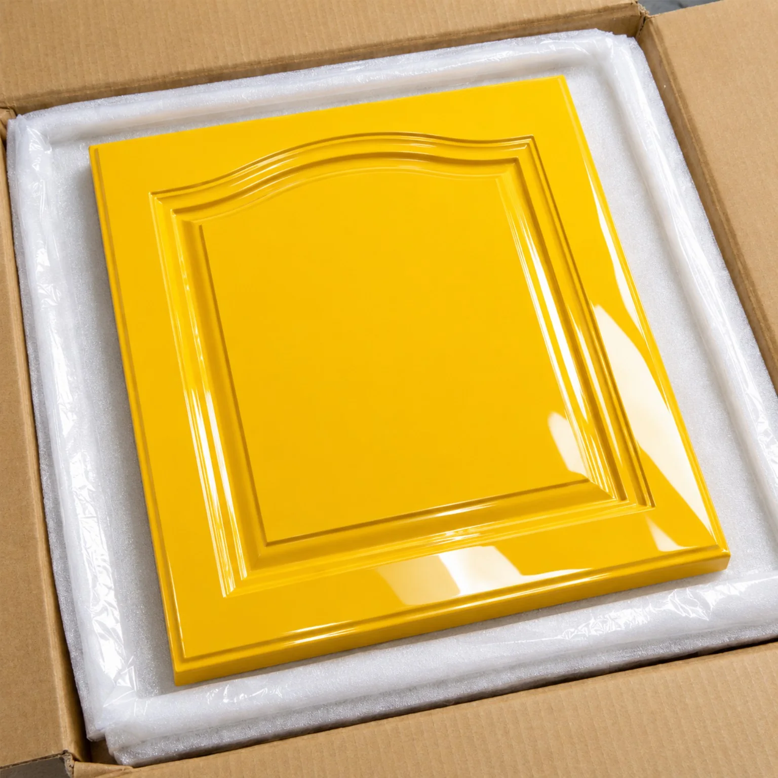 Yellow high-gloss finished panel with a reflective lacquered surface